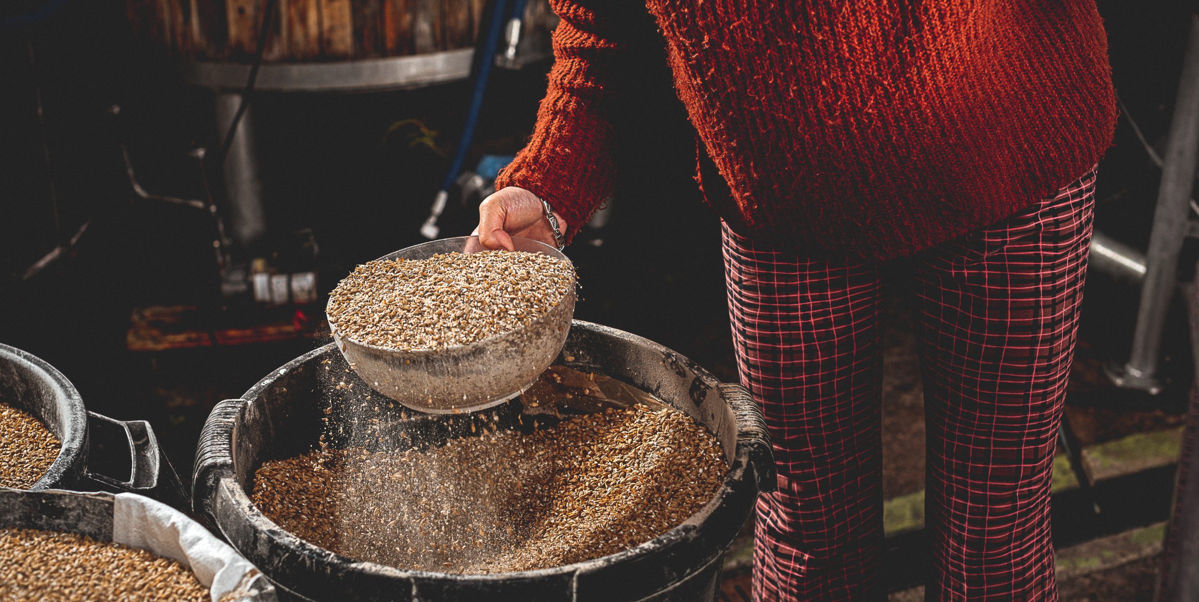 Adrienne holding hops in the brewery as part of the beer making process.